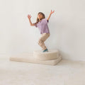 girl playing on boucle mattress and boucle pouf by bettys home, teddy boucle mattress for modern nursery