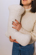 Boucle letter cushion L teddy pillow by bettys home held by woman in cream sweater as birthday gift