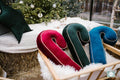 christmas candy cane cushions in three colours near to Christmas tree as christmas decorations