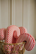 Christmas candy cane cushion red stripes by bettys home some of them sticking out of a wicker basket