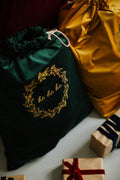 green christmas sack extra large with ho ho ho sign by betty's home and some gifts at front