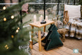 Christmas Tree Cushion Green by Bettys Home next to huge window and christmas tree as christmas decoration
