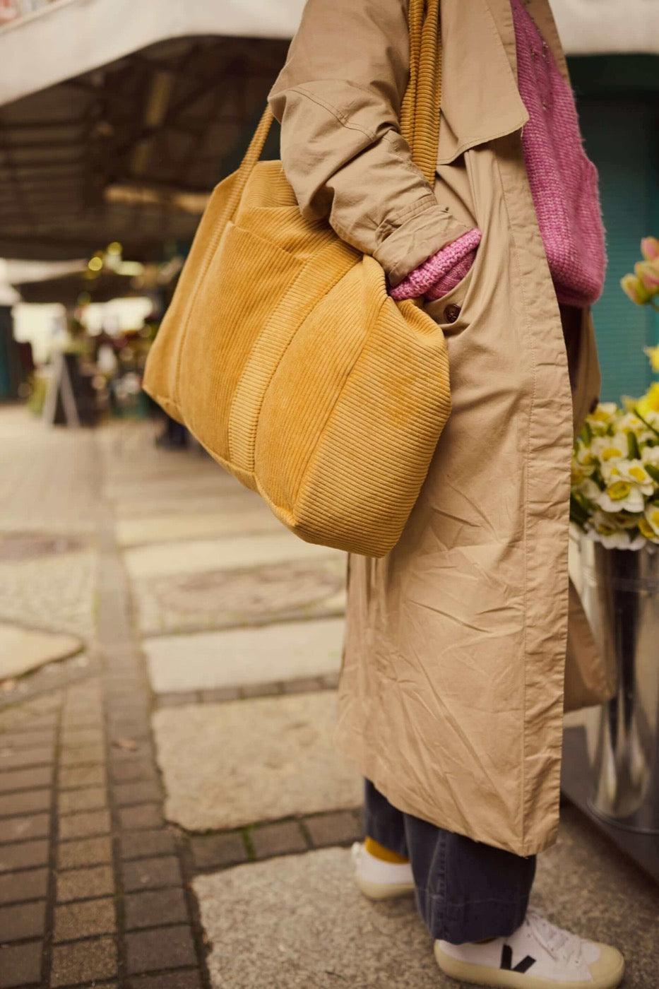 Woman with corduroy shopper bag in yellow. Mom bag. Tote bag c