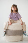 girl sitting on boucle poufs by bettys home kids room decoration