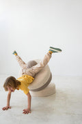 little boy jumping on boucle pouf by bettys home kids and a adults room decoration