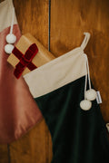 christmas stocking green by Bettys Home with small gift inside. elegant christmas fireplace decorations