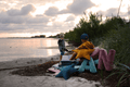 beach view with velvet star cushions and velvet letter cushions on sand by bettys home