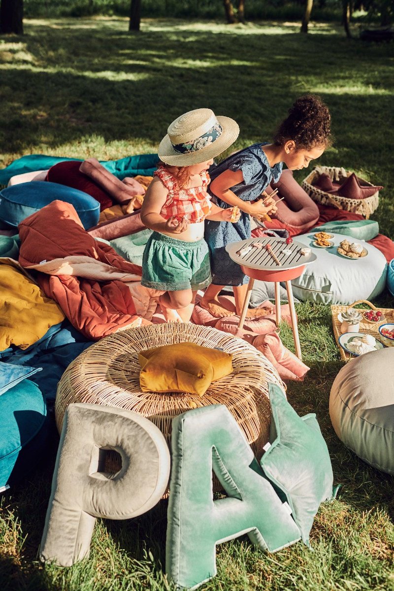 picnic in garden with little girl and velour letter pillows p and a by bettys home