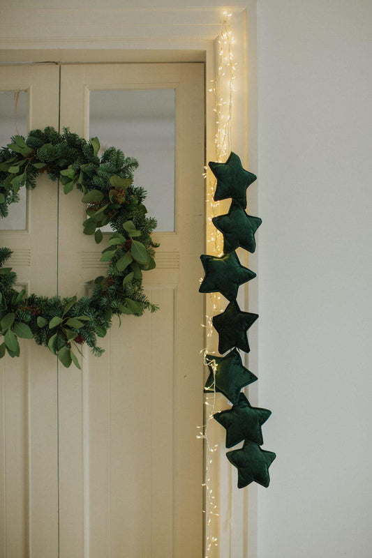 velvet star garland green by bettys home hanging on the door as a Christmas decoration for every home