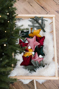 velvet little star pendant green by bettys home with pom poms in christmas trolley next to christmas tree