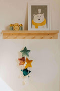velvet little star pendant pink old rose with pompoms by bettys home hanging under shelf in kids room