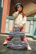 little girl standing with anchor shaped cushion by Betty's Home at school anchor cushion striped cushion