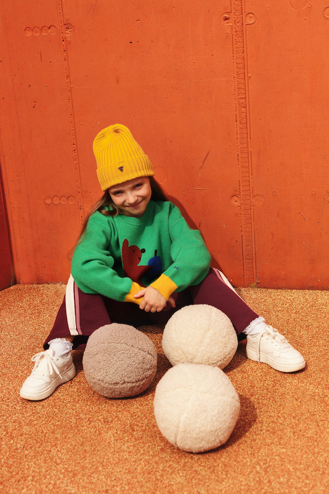 girl at playgroun with boucle ball cushions by bettys home. Ball shaped cushion. Boucle Ball Pillow