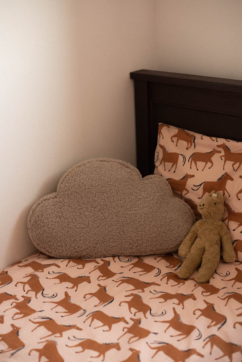 boucle cloud cushion mocha on kids bed. teddy pillow