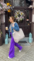 woman walking with coffee and boucle shopper bag by bettys home. boucle tote bag