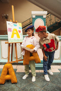 School children at play painting picture with velour letter pillow by bettys home. letter cushions in velvet