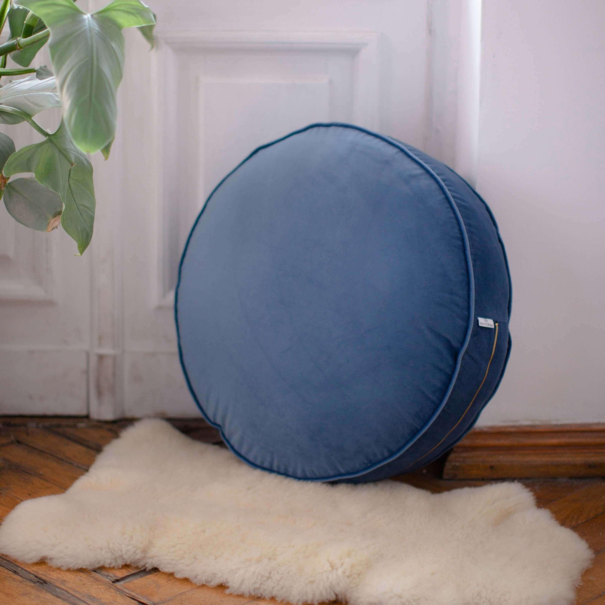 Large Velvet pouf blue on floor