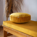 Small Velvet Pouf Yellow on velvet mattress on bench