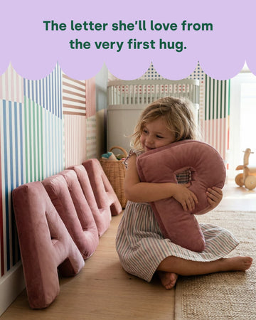 Little girl hugging Letter Cushion P by Bettys home next to letter set PAULA 