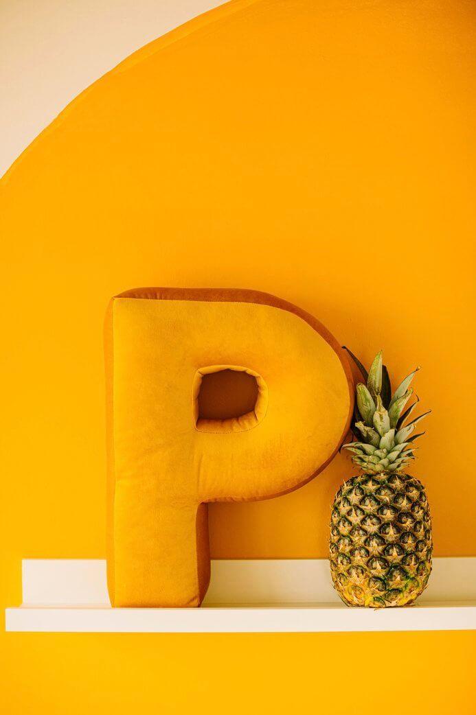 Velvet Letter Cushion P standing on the shelf near to pineaple Bettys Home