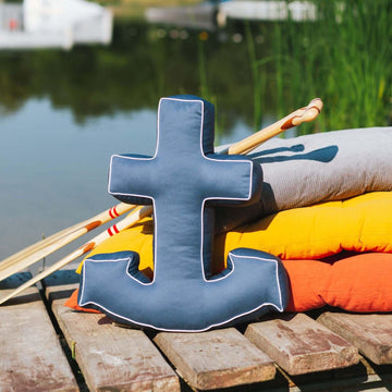 navy blue anchor cushion from bettys home stands on a lakeside pier 
