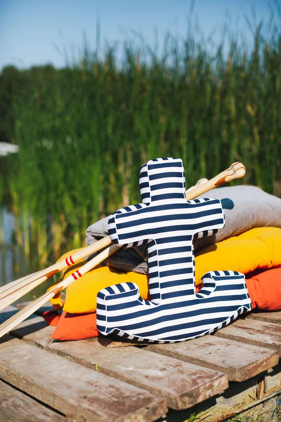 anchor shaped cushion by bettys home standing on stands on the pier by the lake