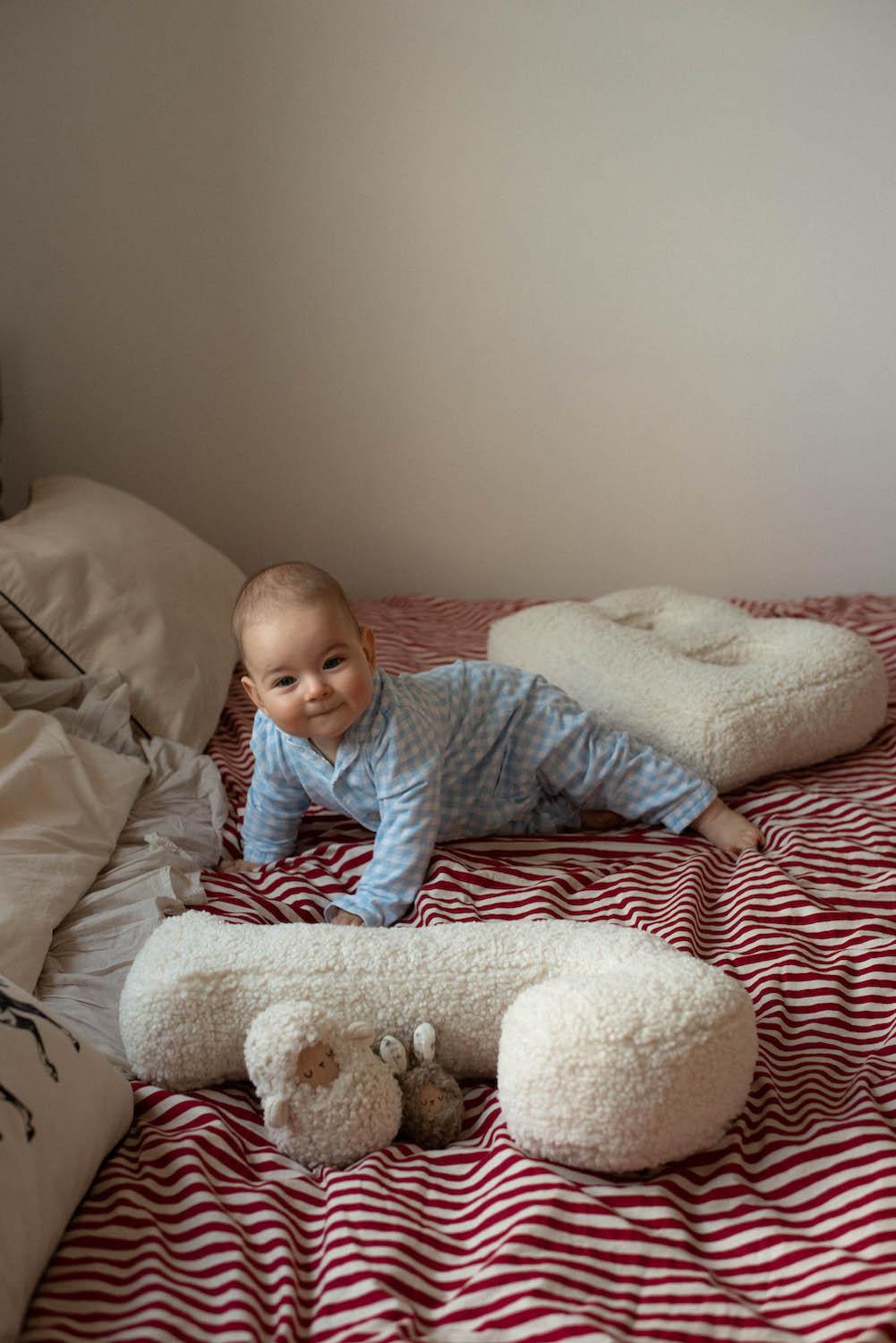 Cute little kid on bed next to Boucle Letter cushion J and by Bettys Home Teddy Letter Pillow