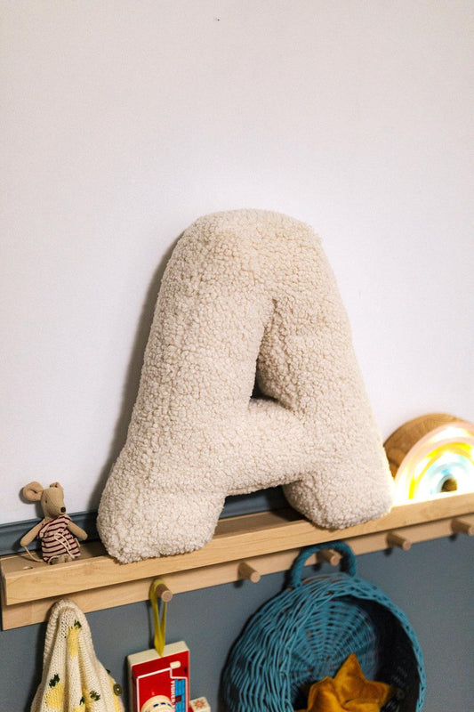 Boucle Letter cushion A by Bettys Home Teddy Letter Pillow on shelf in kids room as kids room deco