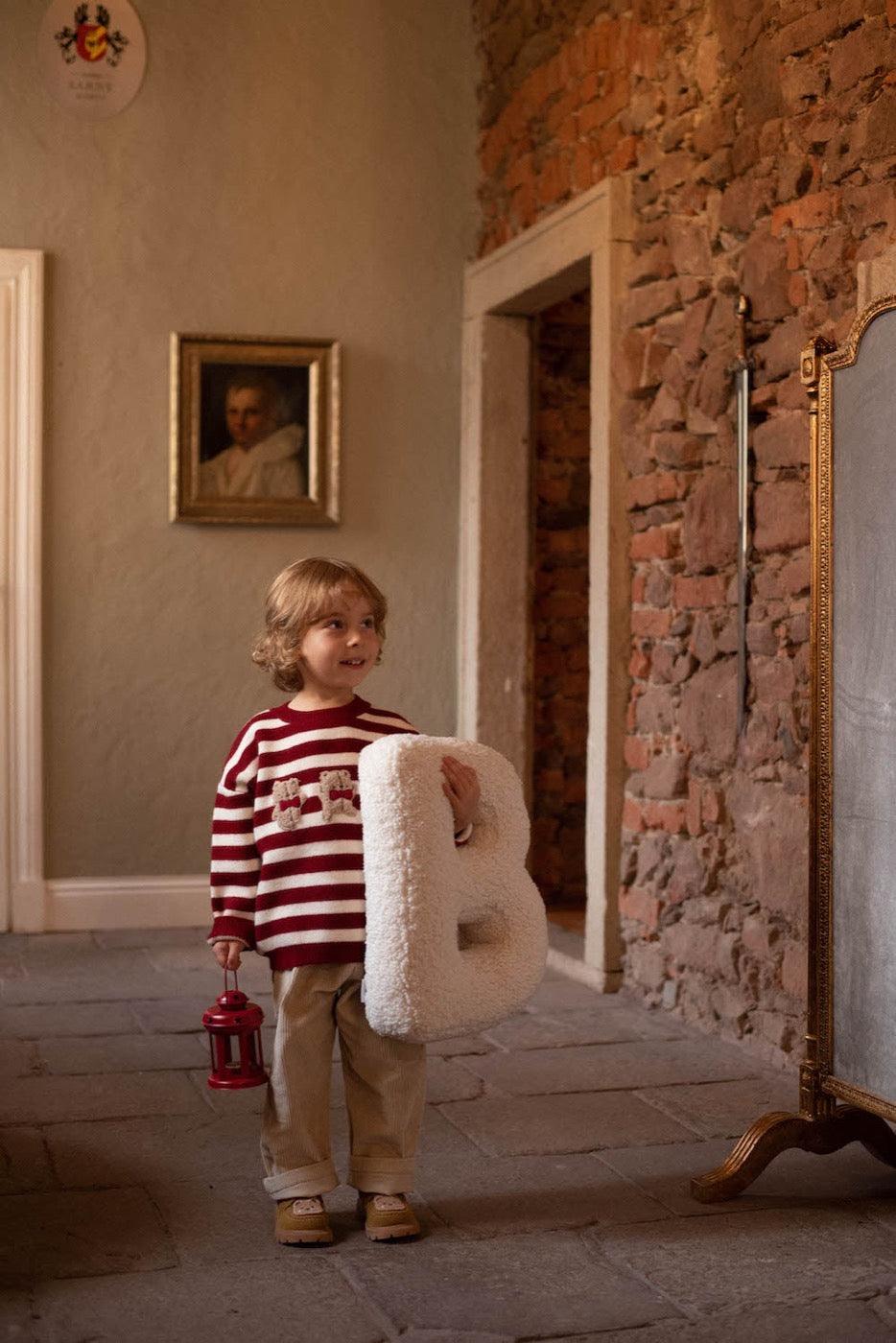 Boucle Letter cushion B by Bettys Home Teddy Letter Pillow held by little boy in red stripe blouse