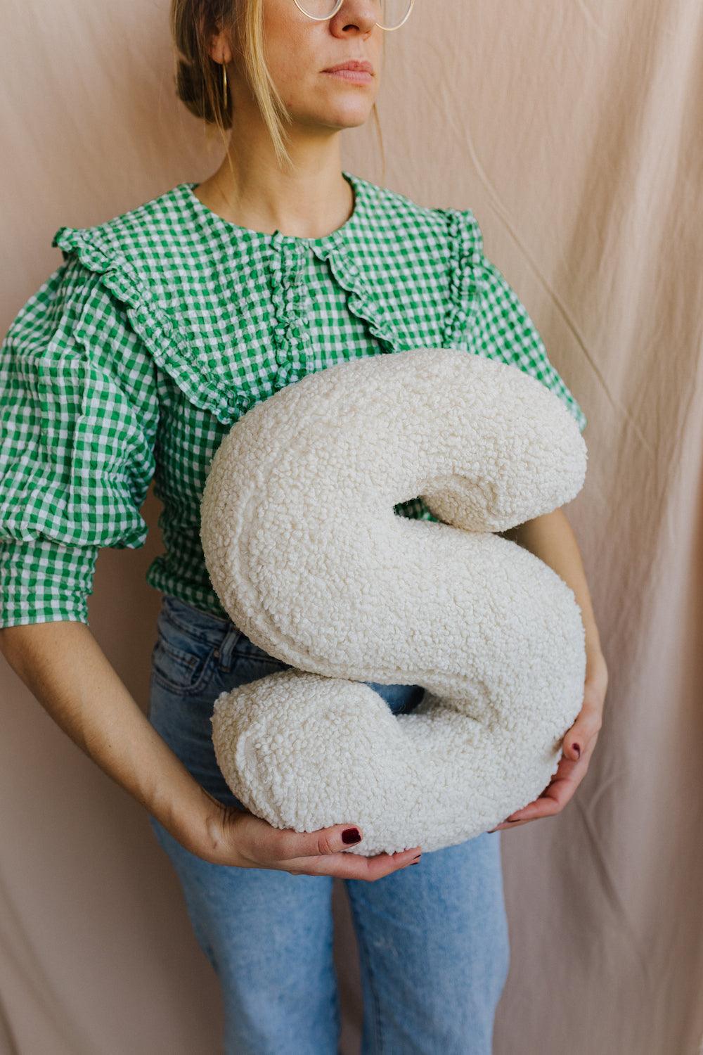 Boucle Letter cushion S by Bettys Home Teddy Letter Pillow held by woman in green shirt and jeans