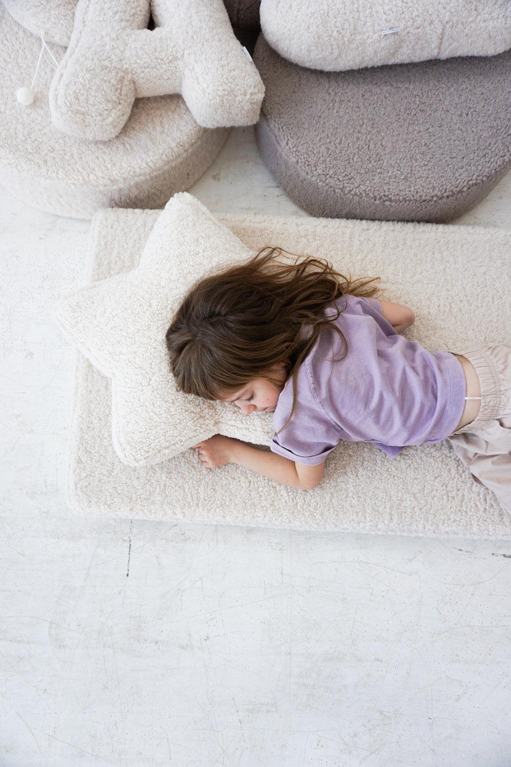 ittle girl sleeping on boucle mattress by bettys home with boucle star under head