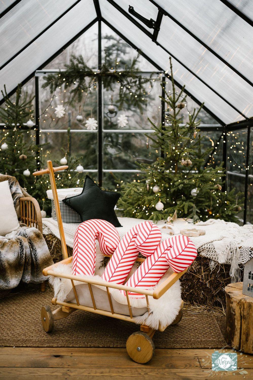 Christmas candy cane cushion red stripes by bettys home lying in a festive trolley as an ornament under the Christmas tree