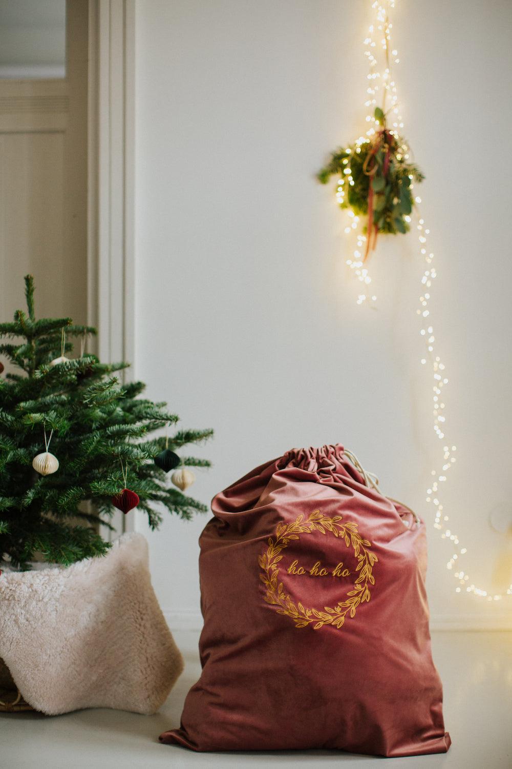 christmas sack in pink with embroidered ho ho ho by Bettys Home next to Christmas tree. christmas sack extra large 