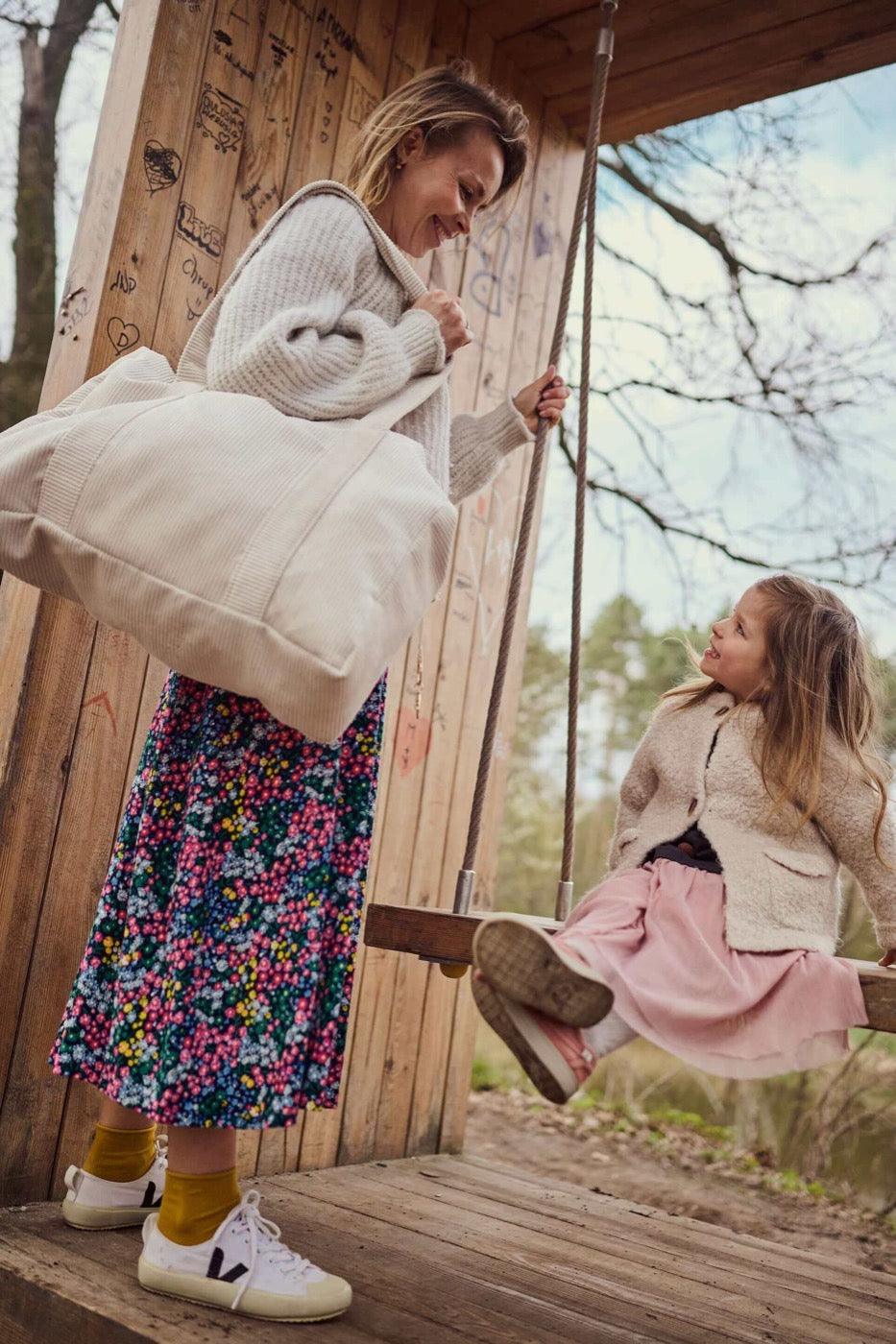 Young mom with daughter and corduroy shopper bag in cream colour. Tote bag by bettys home