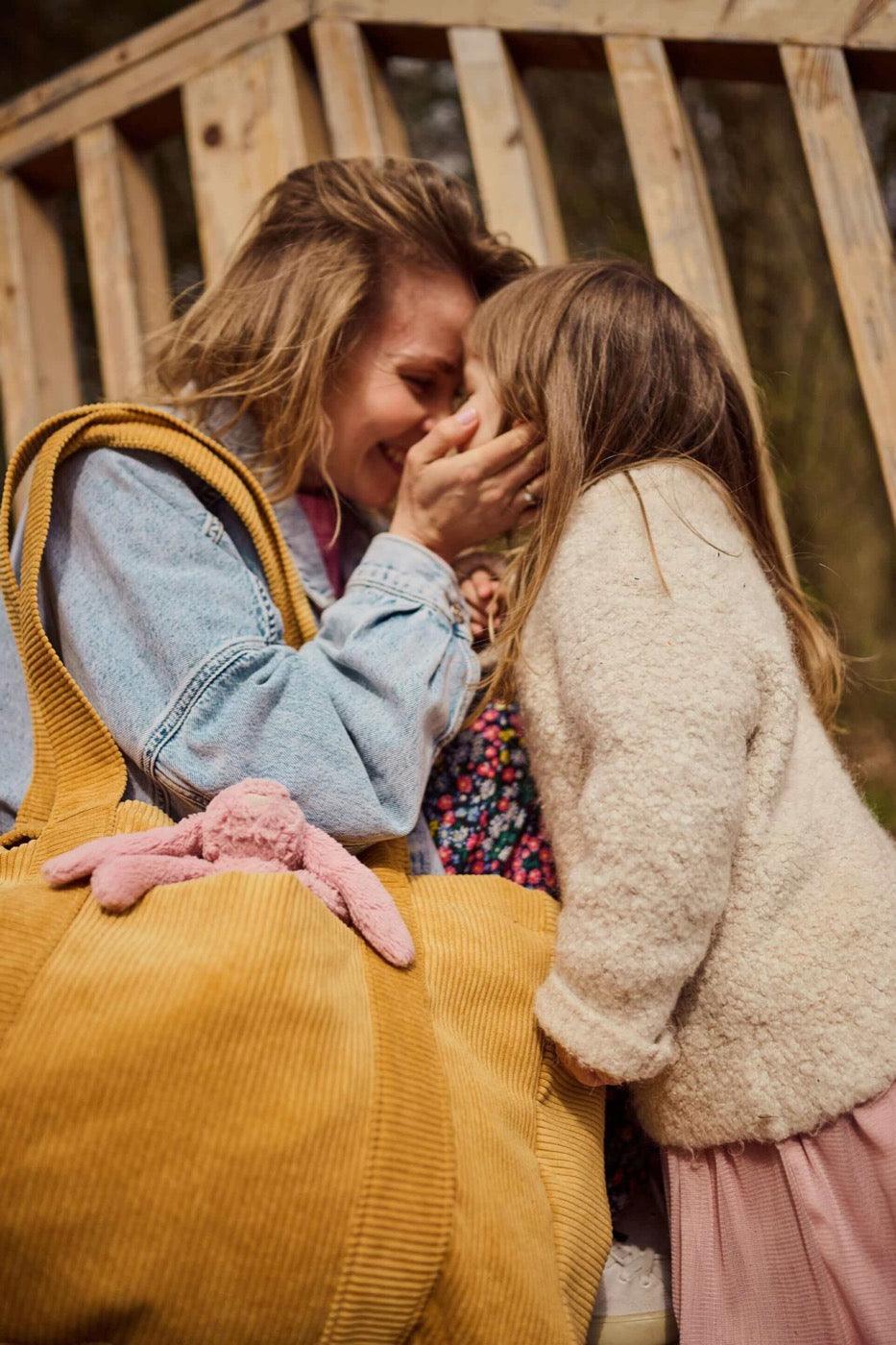 Woman with daughter and corduroy shopper bag in yellow. Mom bag. Tote bag