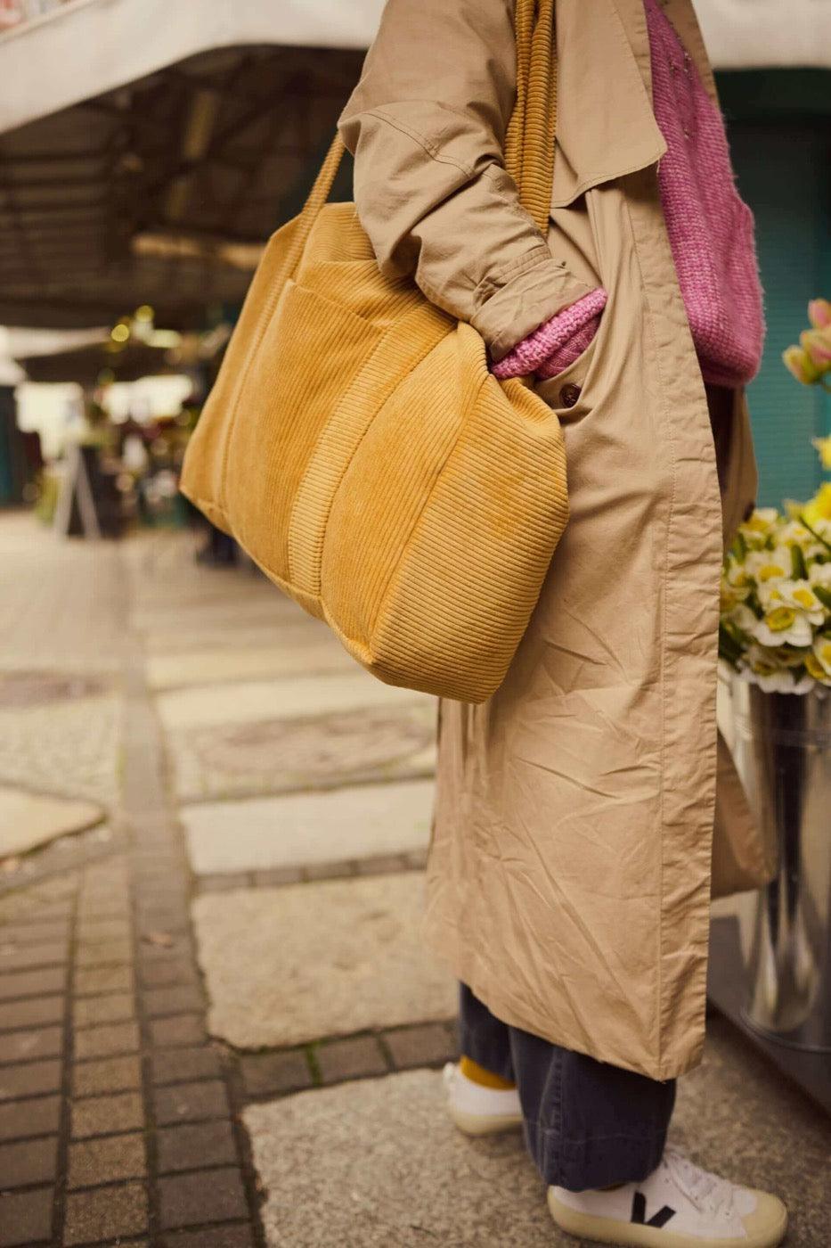 Woman with corduroy shopper bag in yellow. Mom bag. Tote bag c