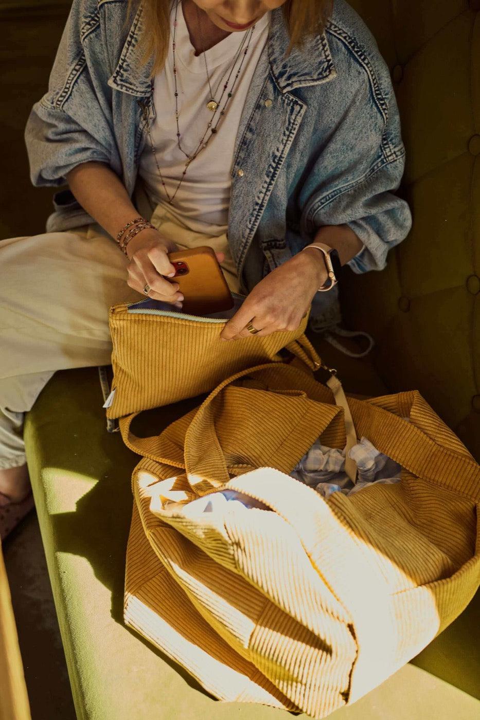 Woman with corduroy shopper bag in yellow. Mom bag. Tote bag d