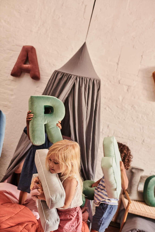 little girl in kindergarten with Velvet Letter cushion by bettys home