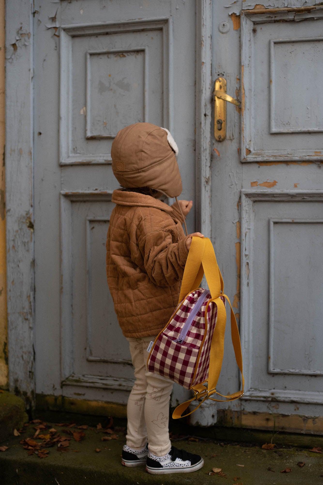 little boy with checkered backpack by bettys home. Gingham retro backpacks for kids trip