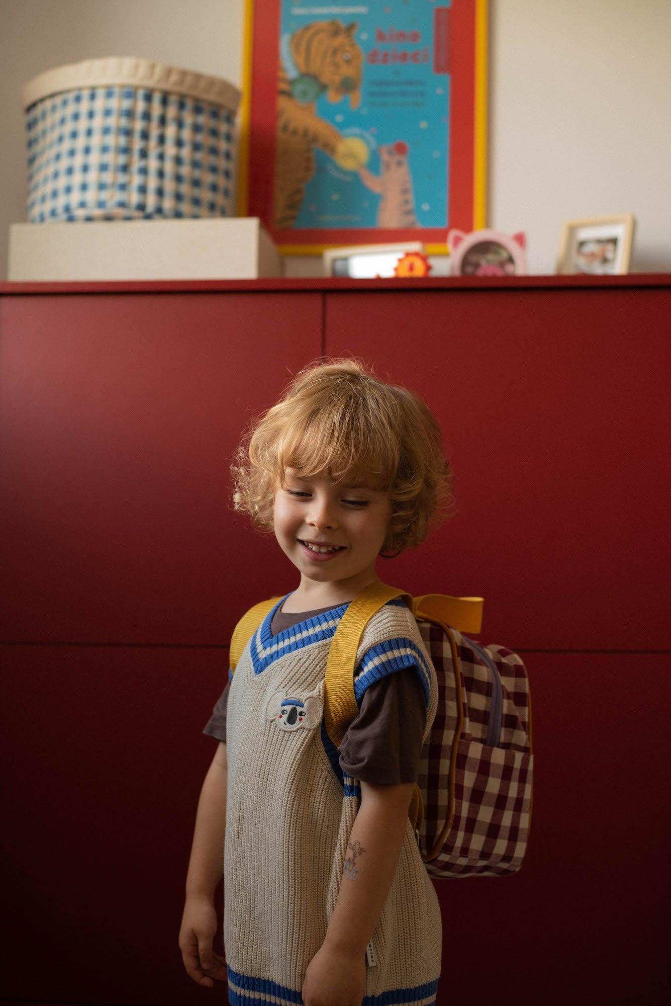 little boy with school backpack for kids in gingham red. Checkered backpack 