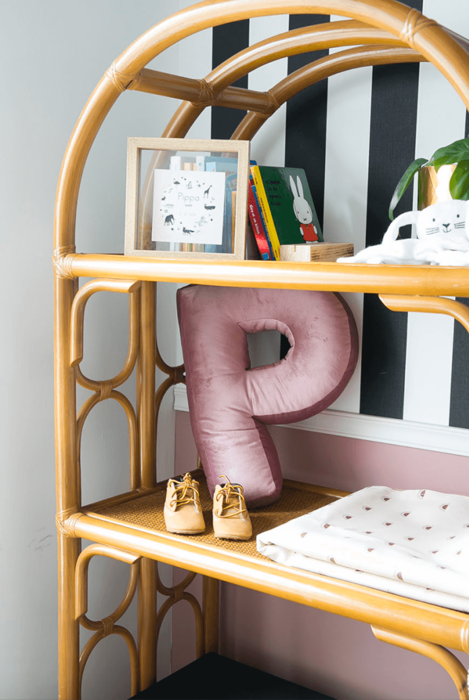 bookshelf in living room with velvet letter pillow p pink by bettys home