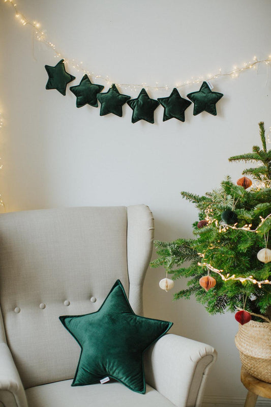 velvet star cushion green by bettys home on armchair near to christmas tree and star garland on wall