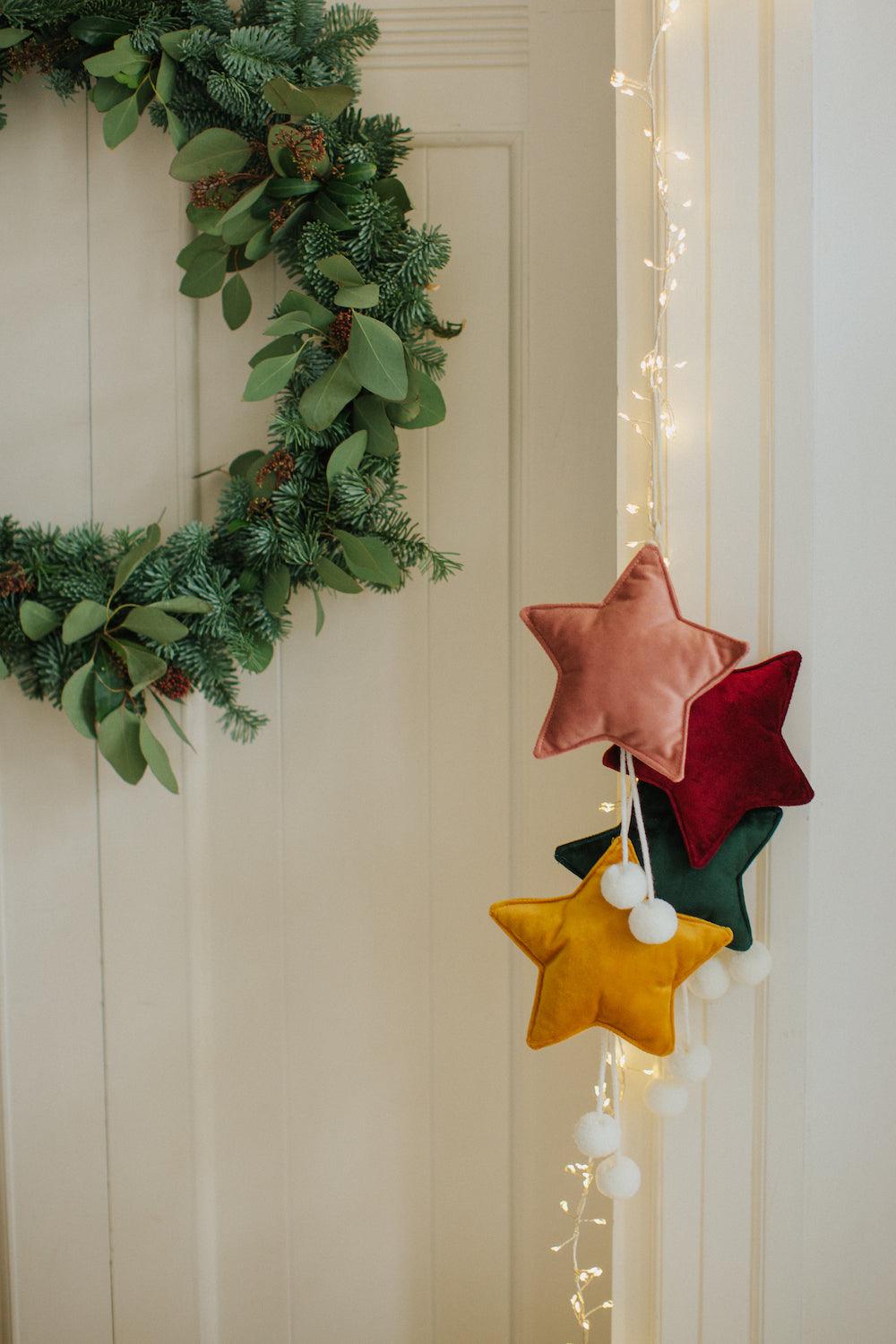 velvet little star pendant green by bettys home hanging on door with pink star, yellow star, wine star as christmas decorations