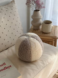 boucle ball cushion mixed colour mocha and cream by bettys home on chair in living room