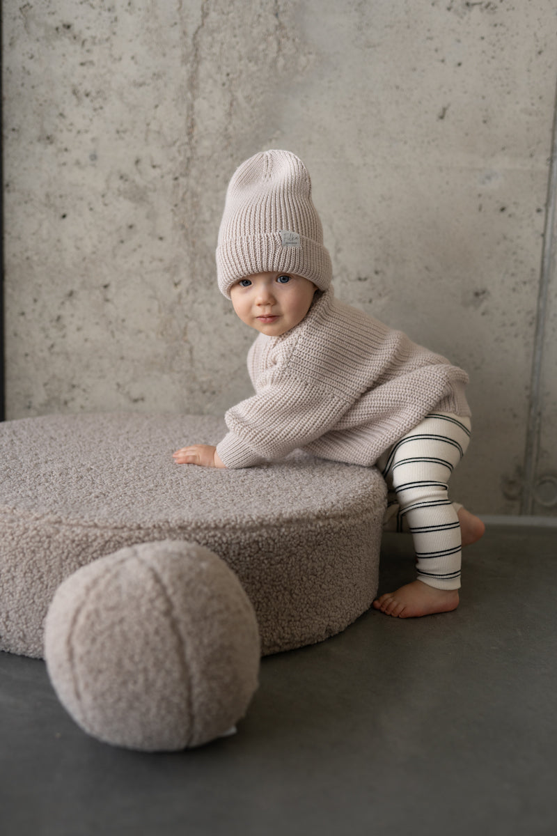 baby boy playing with taupe boucle ball cushion by bettys home. Boucle floor cushion