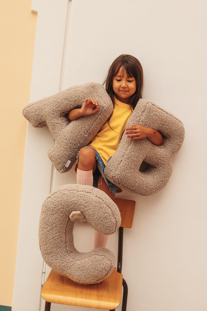 Children on chairs with boucle letter cushion A and B by Bettys Home. kids room deco