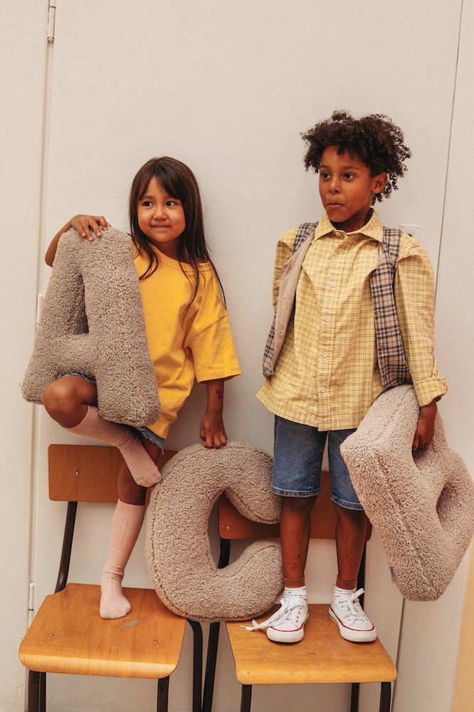 Children on chairs with boucle letter cushion A and B by Bettys Home. kids room deco 23