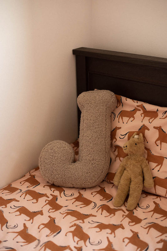 Boucle letter cushion J mocha on kids bed. Teddy pillow by bettys home