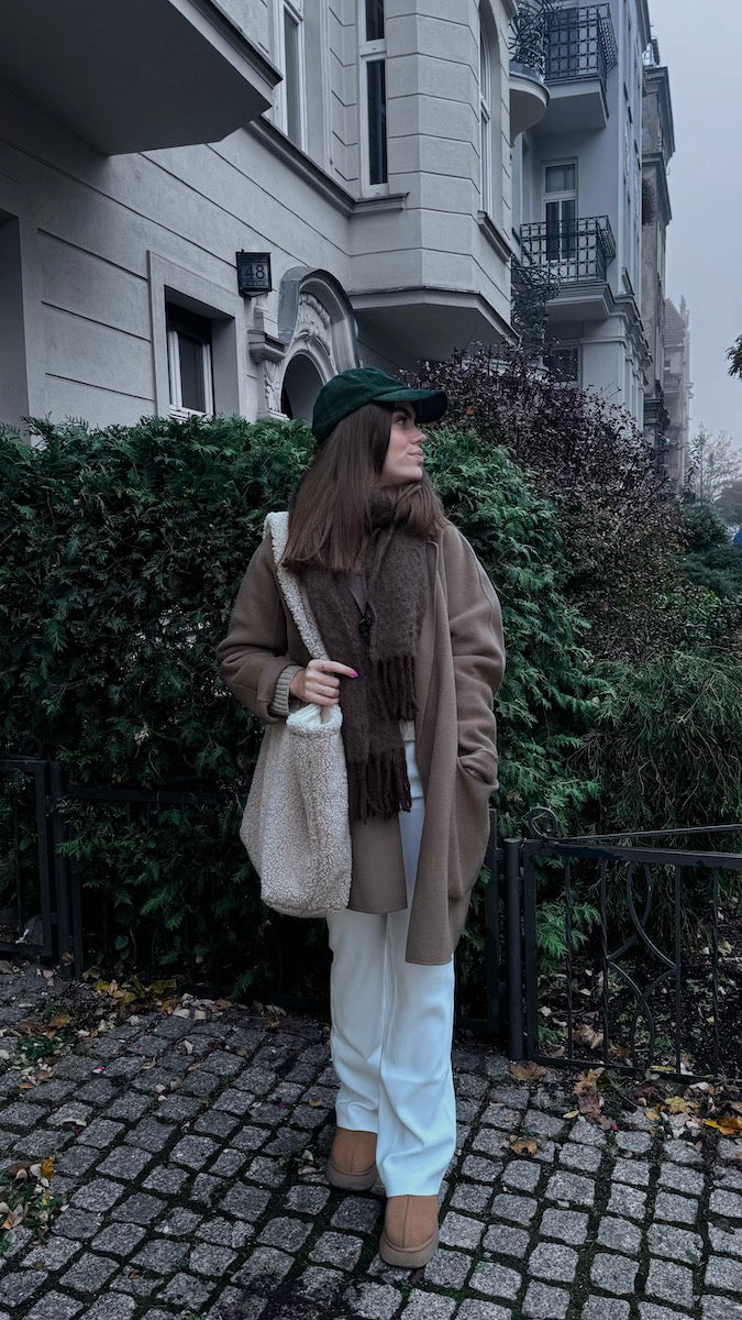 woman standing in front of house with boucle shopper bag by bettys home. boucle tote bag 