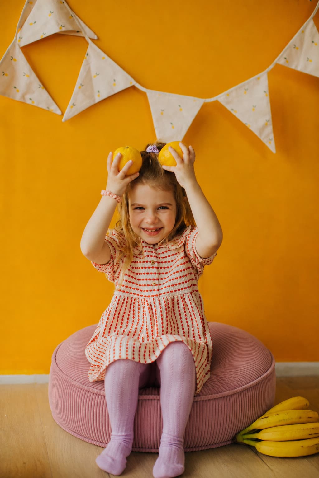 little cute girl sitting on large corduroy floor pouf pink by Bettys home 
